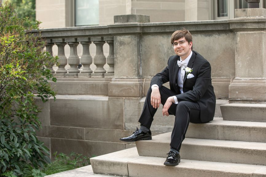 groom smiling sitting on stairs 