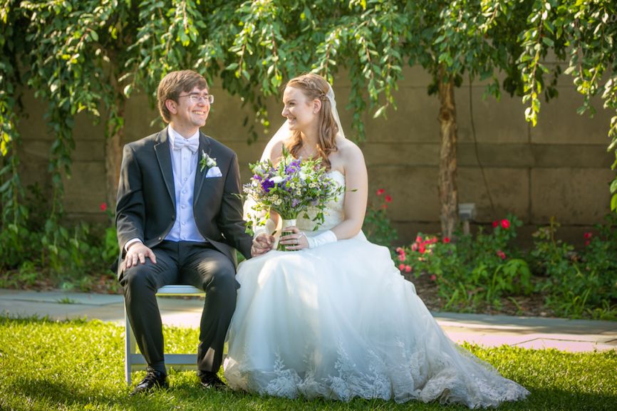 bride and groom sitting and smiling