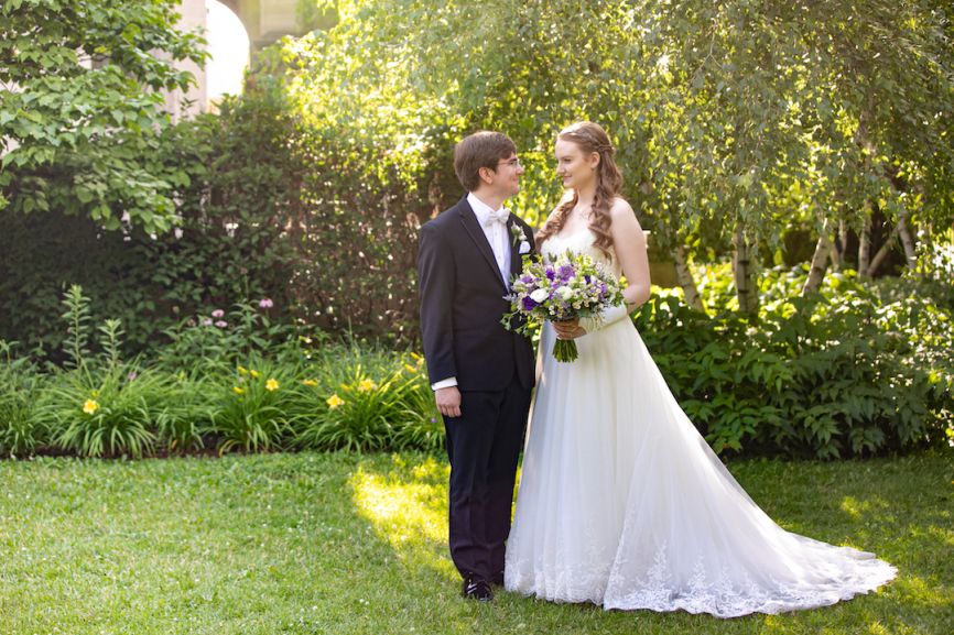 bride and groom posing in garden