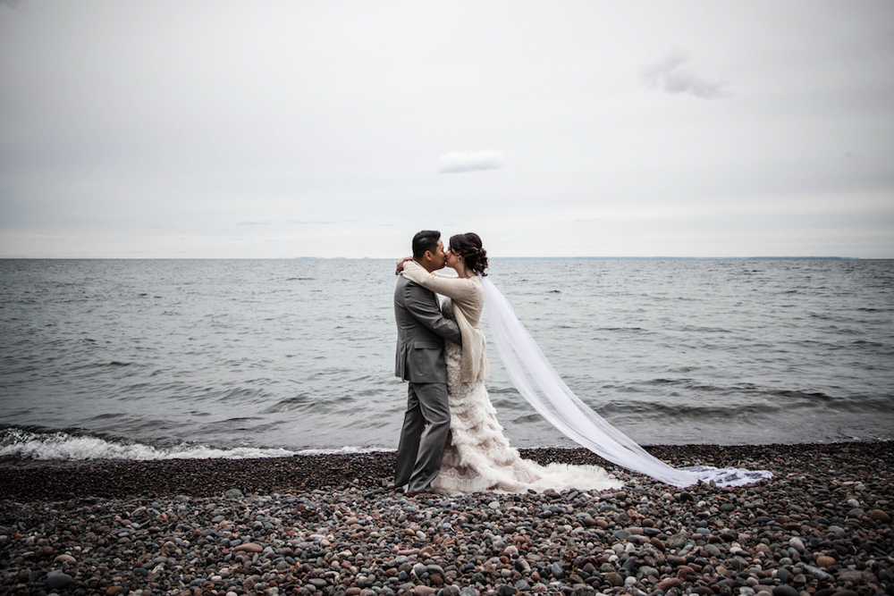 bride and groom on the shore of lake superior