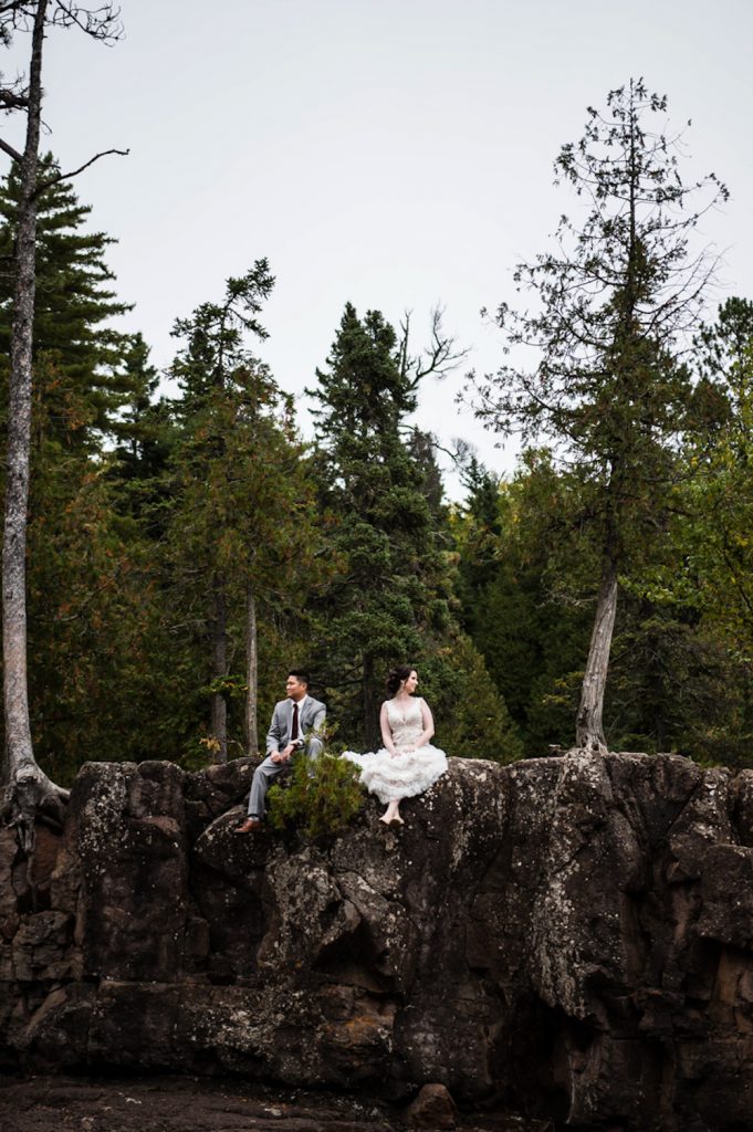 bride and groom sitting on ledge