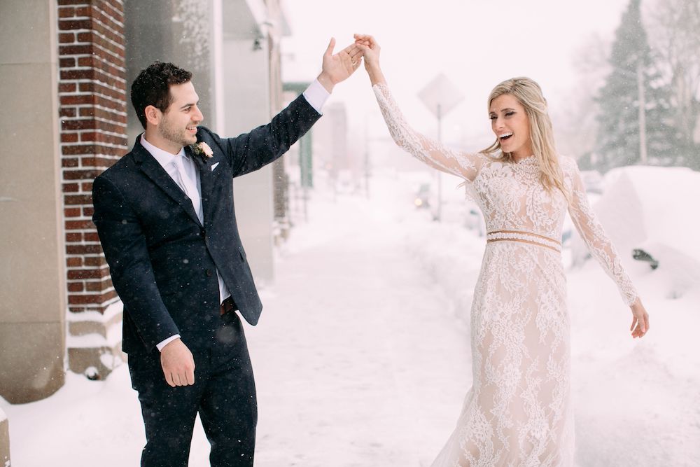 bride and groom dancing in the snow
