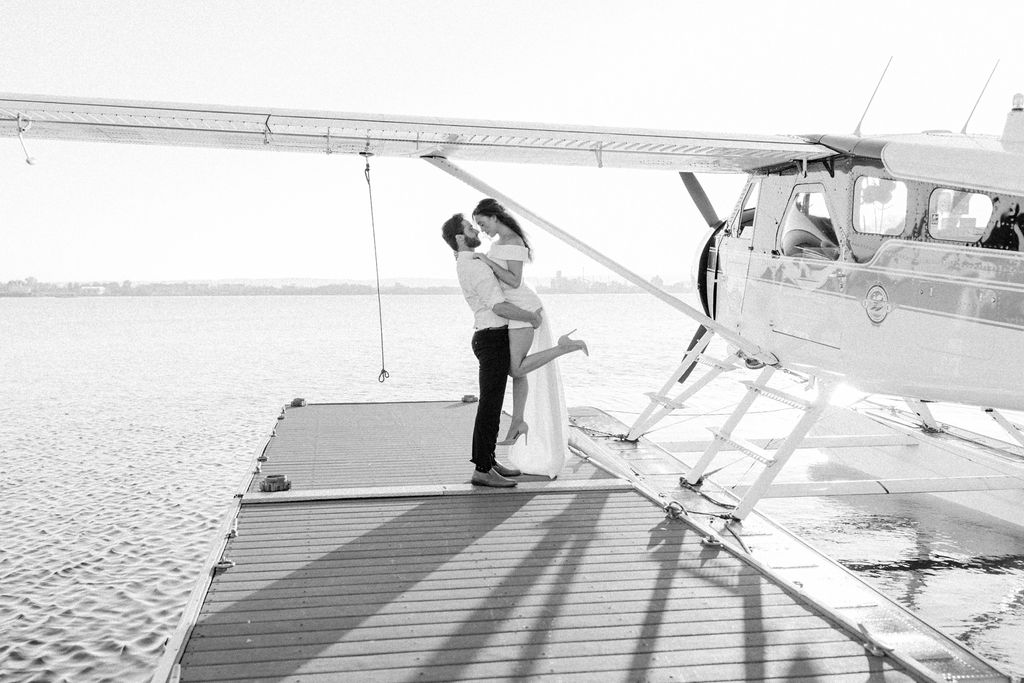 bride and groom next to small plane