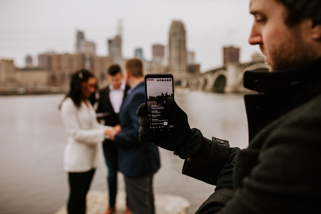 man live streaming ceremony on an iphone