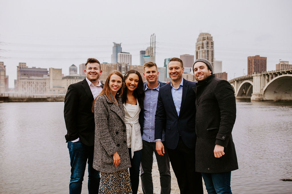 bride and groom posing with friends