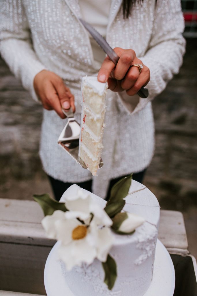 bride holding up a slice of cake