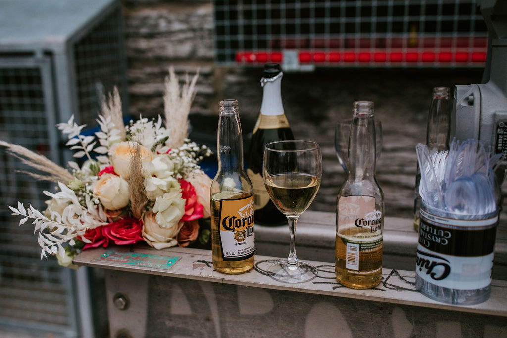 wine glass and beer bottles on bar