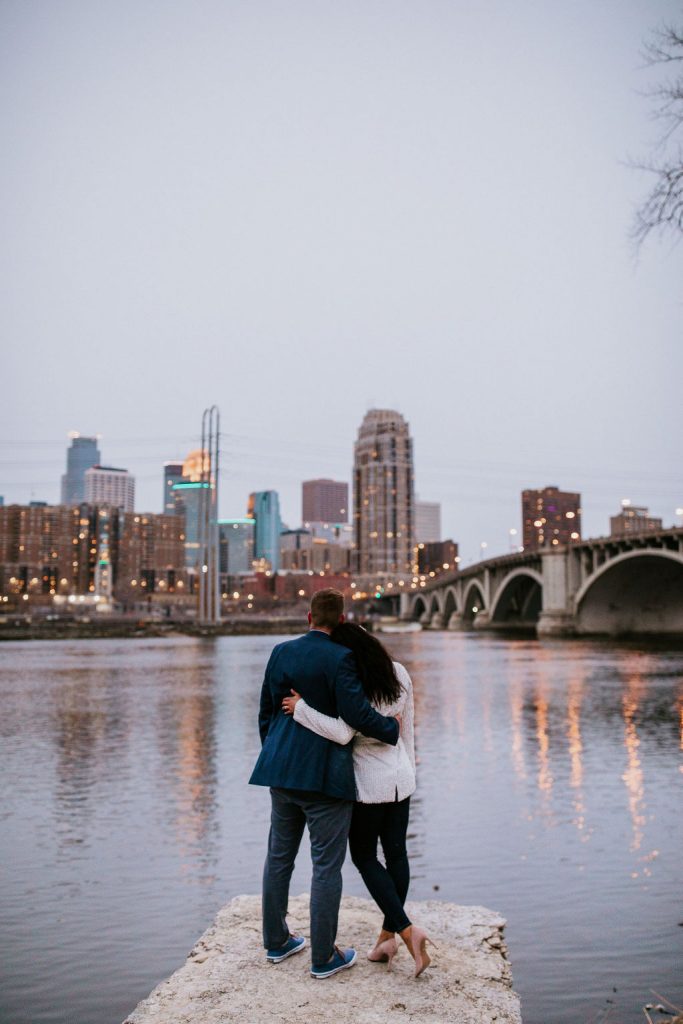 bride and groom looking out over river