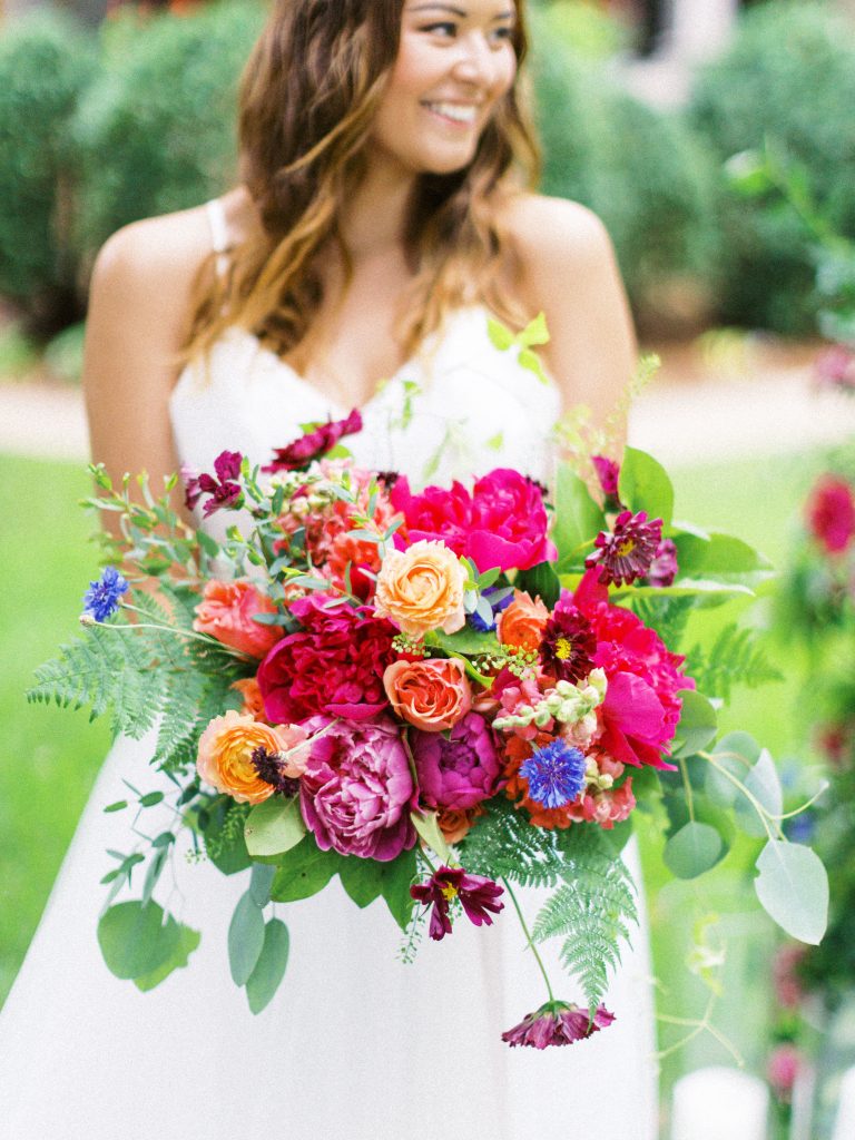 Bride holding colorful bouquet 