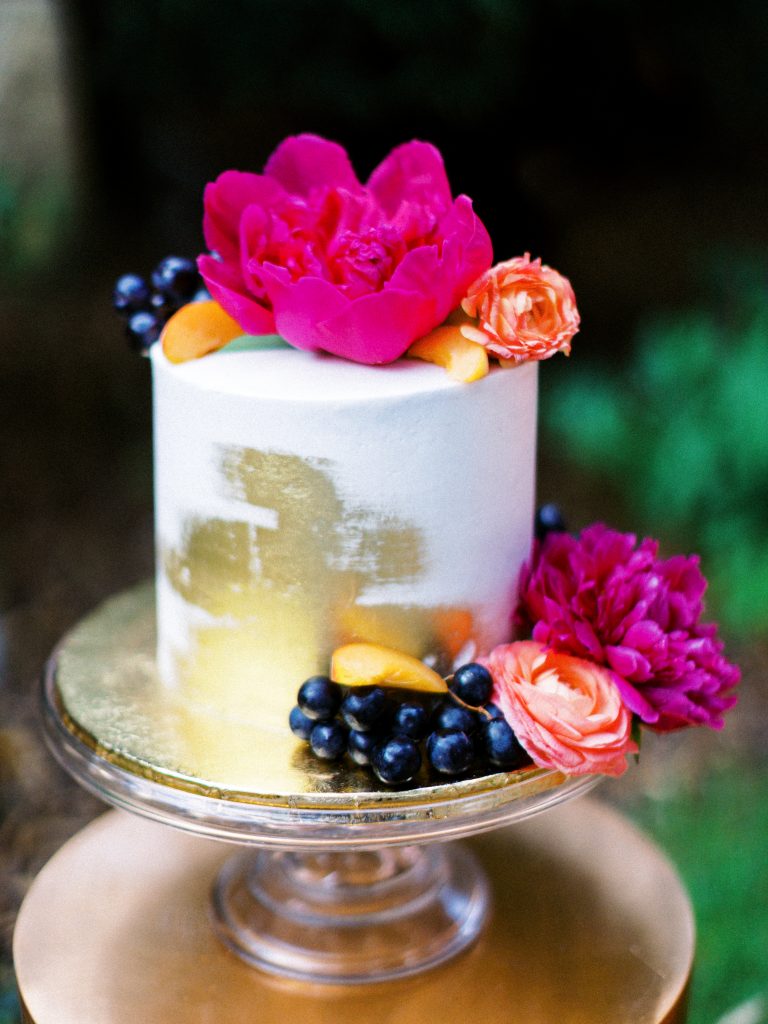 Wedding cake decorated with bright colored flowers