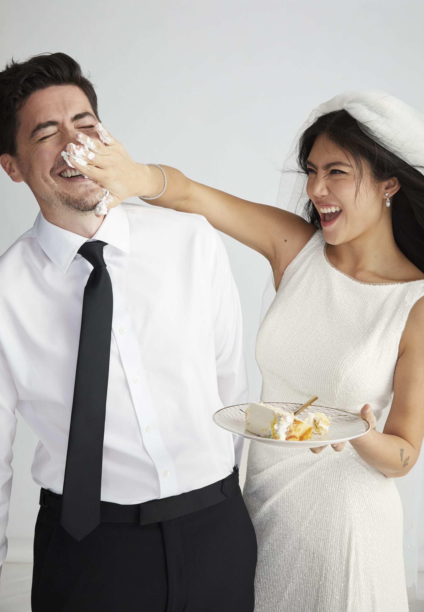 A couple eating cake on their wedding day