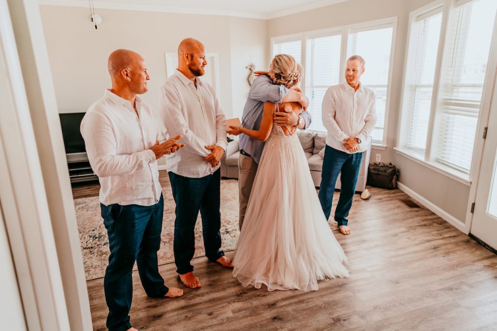 Bride hugging Dad before wedding ceremony - romantic beach wedding in Gulf Shores