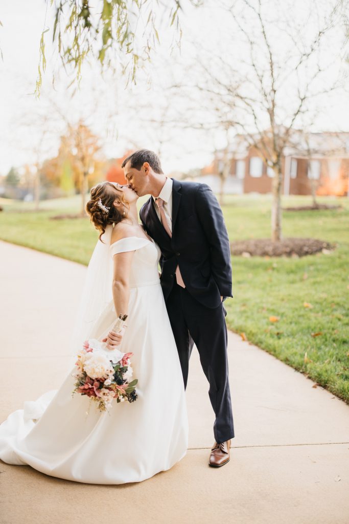 bride and groom kissing in fall wedding in north carolina