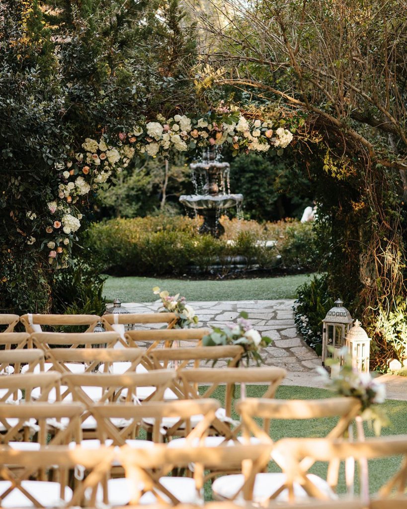 outdoor wedding ceremony with floral backfrop