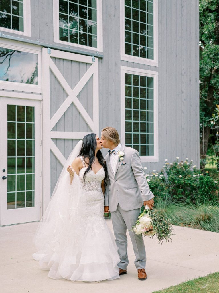 bride and groom at romantic barn wedding in Texas