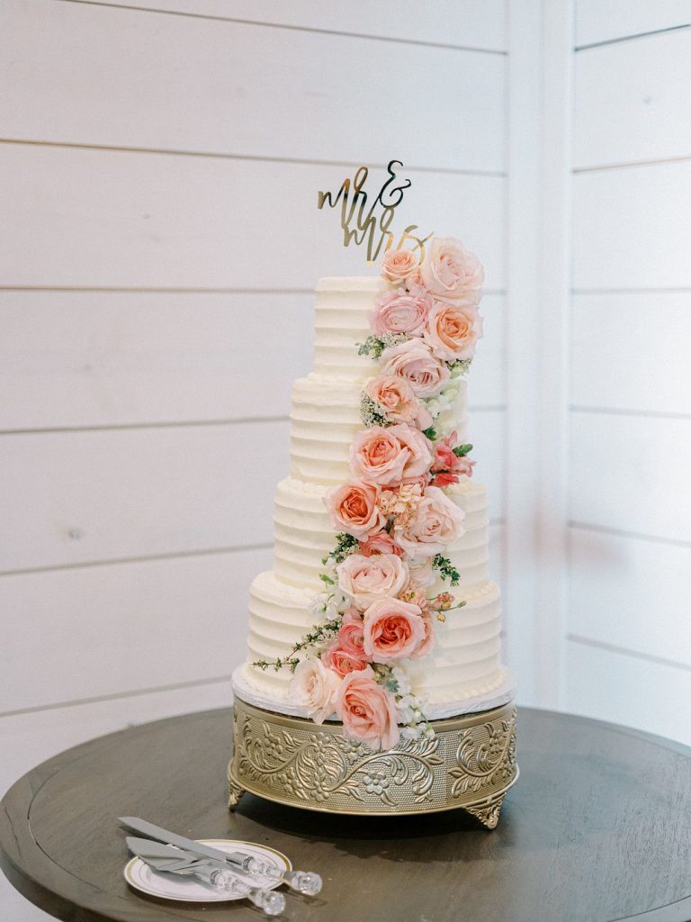 tiered wedding cake with pink flowers