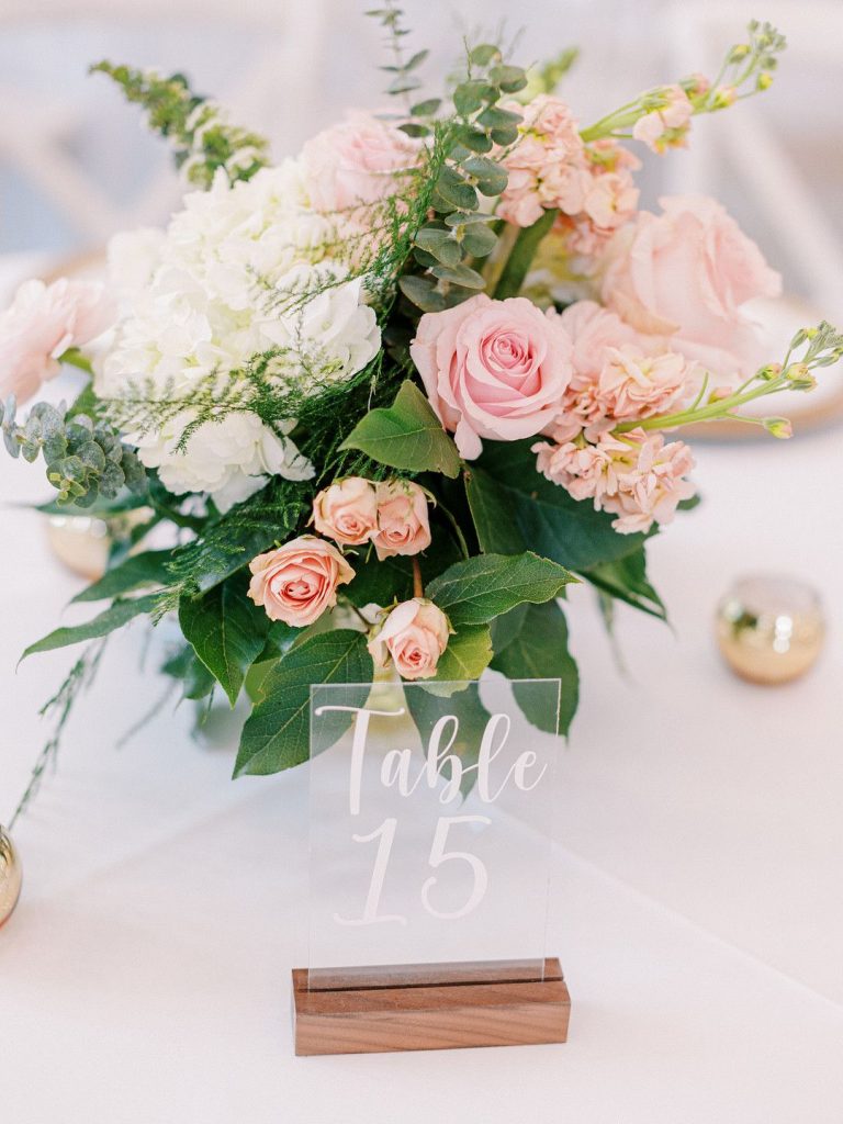 wedding table sign and flowers at romantic barn wedding in Texas