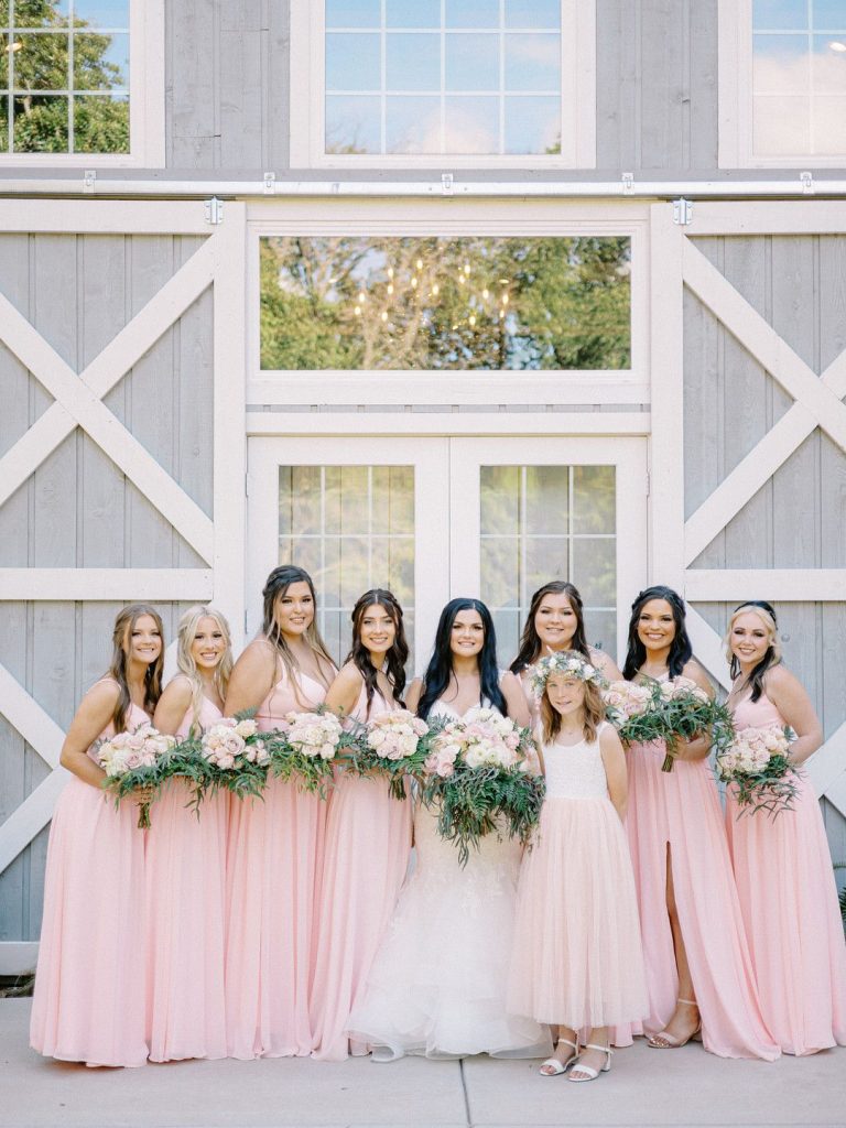 bride and bridesmaid at romantic barn wedding in Texas