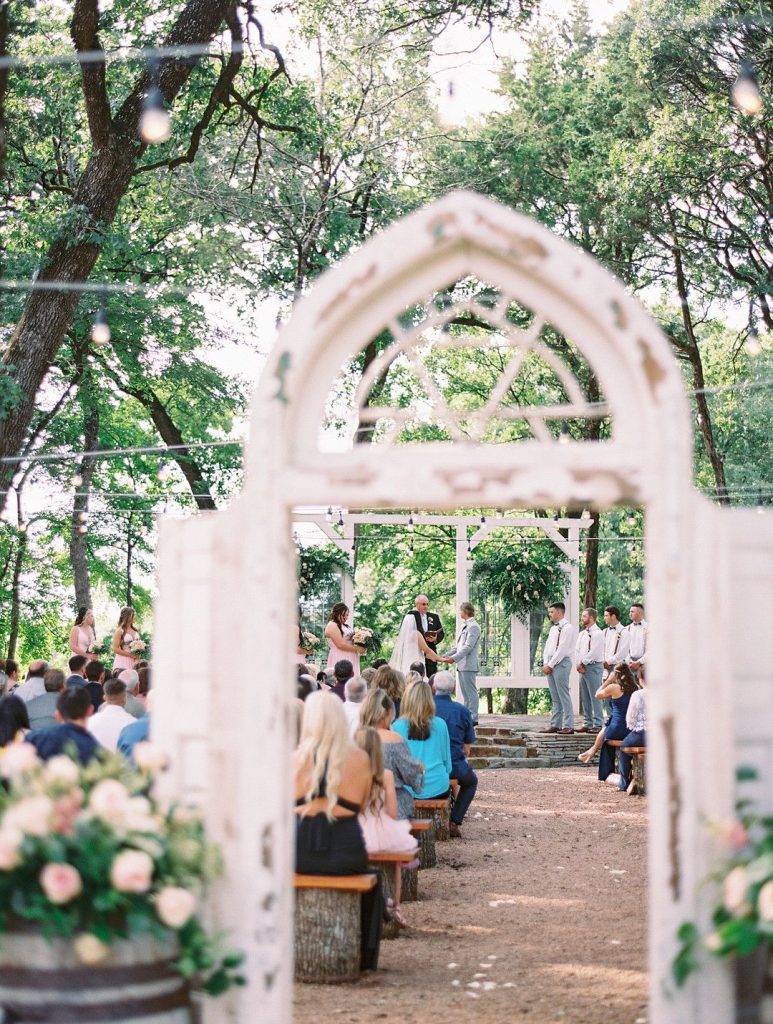 outdoor wedding ceremony decor with rustic door arch