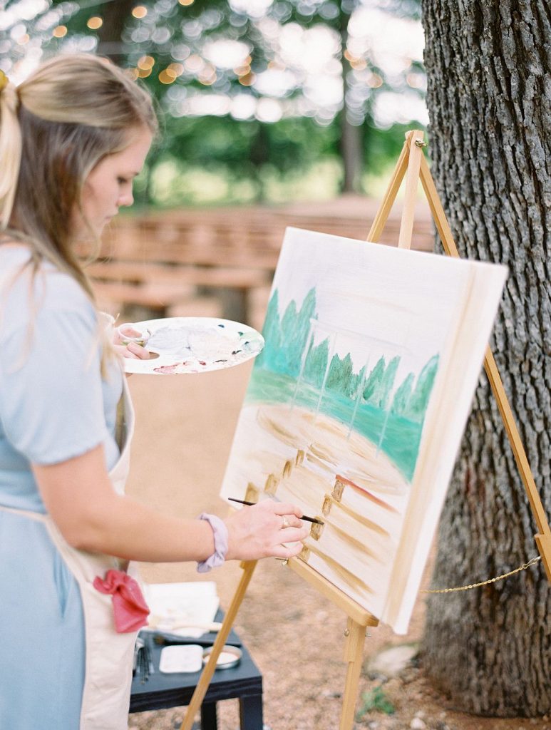 painter at romantic barn wedding in Texas