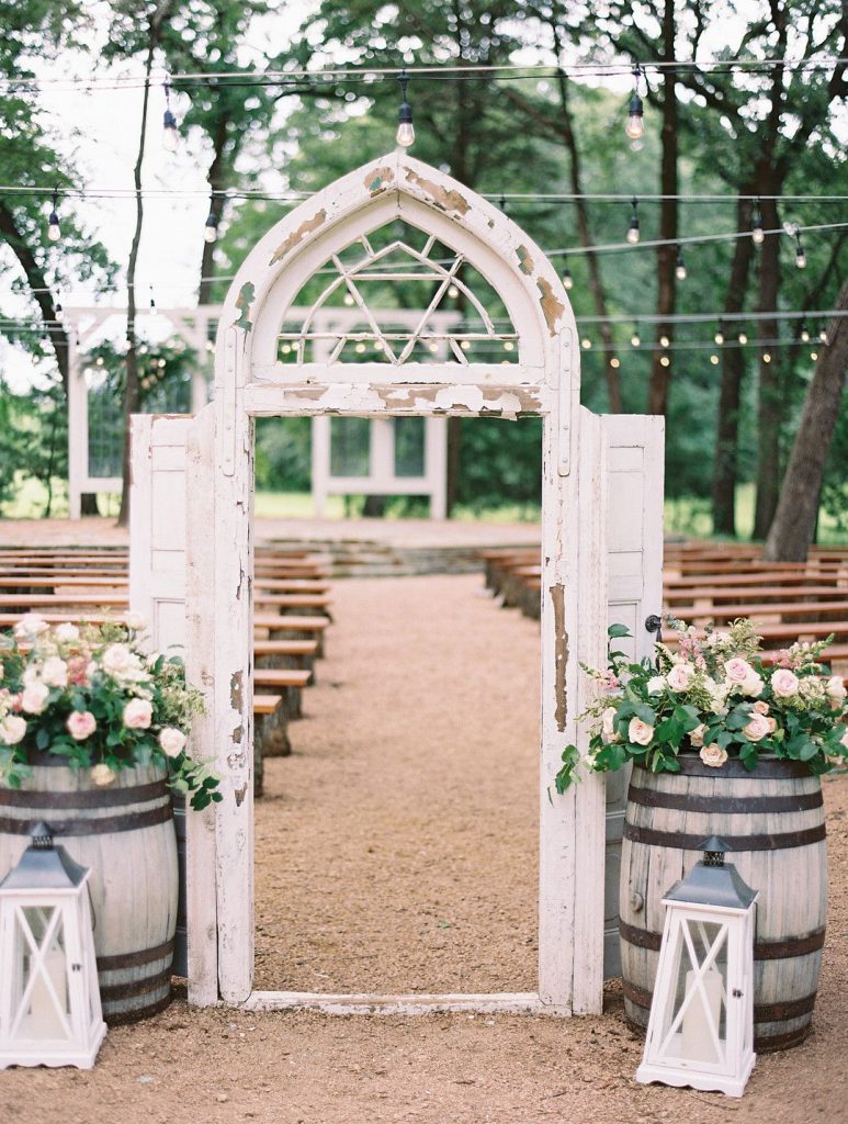 outdoor wedding ceremony decor with rustic door arch