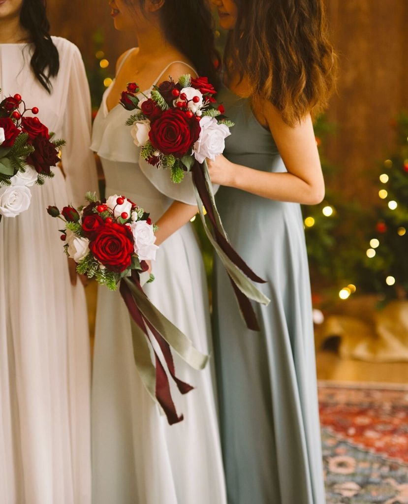 Bridesmaids in green dresses standing next to a bride