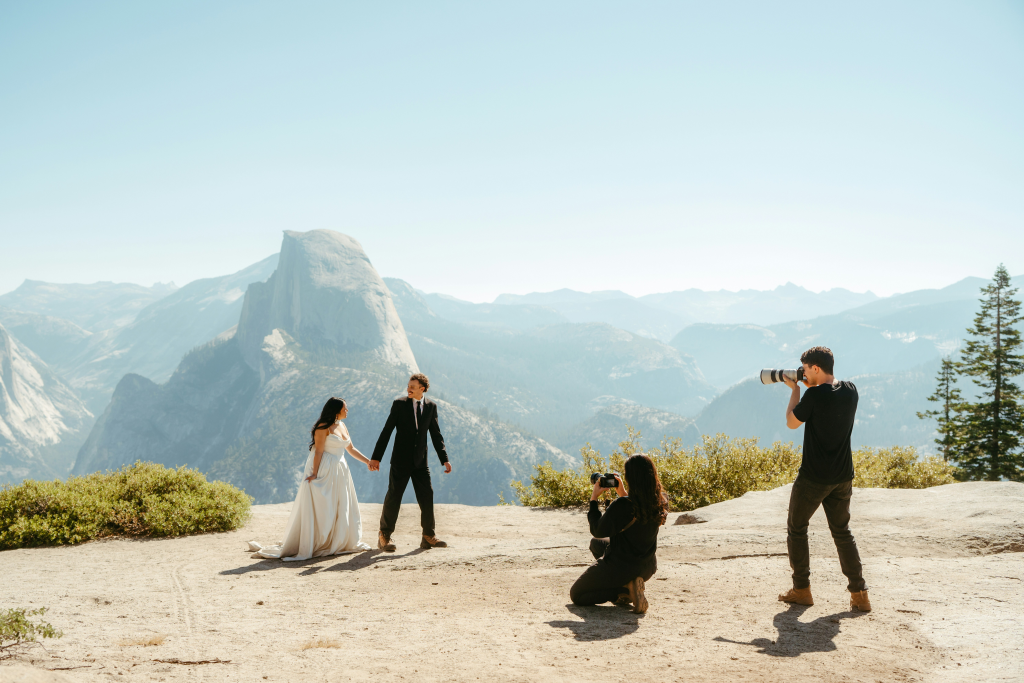 Wedding photographers taking photos of a bride and groom.